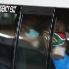 Image of a masked women at an Emergency Exit