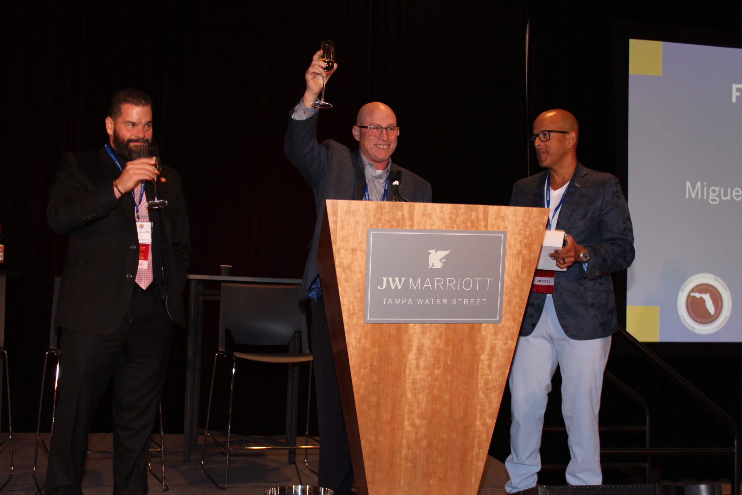 Dr. Jesse Lipnick raising a glass during a toast at the 2022 FSIPP Conference.